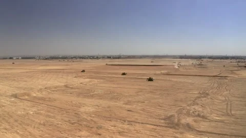 Broad drone view of grading vehicles on open sandy ground 库存影片 346425369