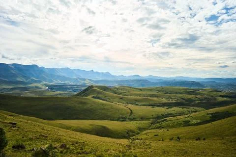 Broad Landscape Featuring Gentle Lighting And Dramatic Mountain Formations Stockfoto's
