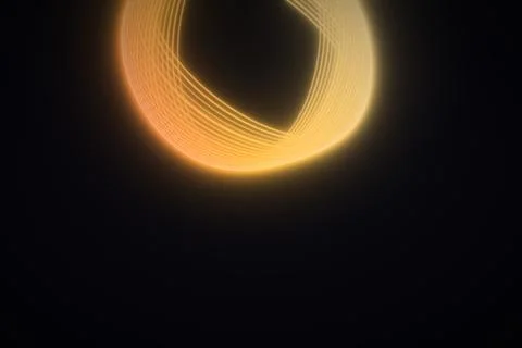 A broad loop of fine orange and golden light trails arcs across the upper p.. Stock Illustration