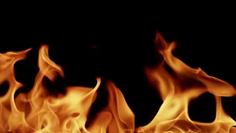 Broad orange fire flames dancing on a black background Stock Footage 329733990