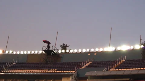 Broadcast camera operator filming a sporting event in an empty stadium Stock Footage 136184798