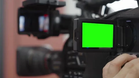 Broadcast camera operator preparing equipment for television coverage with Stock Footage 337062026