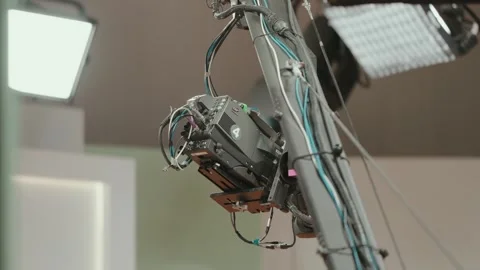 Broadcast camera on studio crane with cables during production setup Video stock 328928611