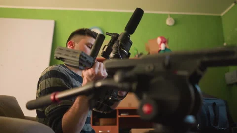 Broadcast director focusing on camera and microphone setup for production Vídeo Stock 317560884