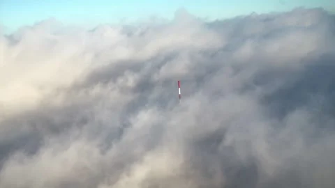 Broadcast tower hidden in the clouds by sunset drone shot Inspire2 4k Stock Footage 252499804