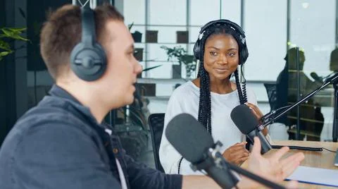 Broadcasts a Live Radio Interview With Spbd. Male Host Sharing Content. Stock Photos