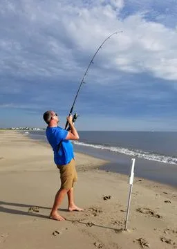 Broadkill Beach, Delaware, U.S.A - May 16, 2022 - A man reeling a big fish us Stock Photos