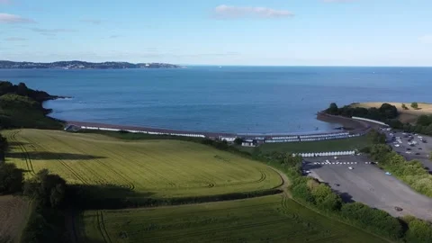 Broadsands, Devon, England: DRONE VIEWS: Broadsands beach, beach huts and sea Stock Footage 201675909