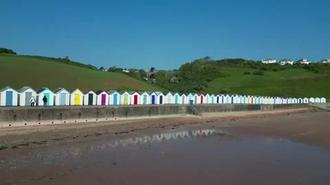 Broadsands, S. Devon, England: DRONE VIEWS: Beach huts &amp; reflection, sea &amp; waves Stock Footage 241146387