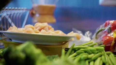 Broccoli and cut chicken cubes on a kitchen counter Stock Footage 85064735