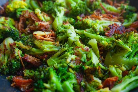 Broccoli and pieces of pulled pork meat, roasted on the plate, close up Stock Photos