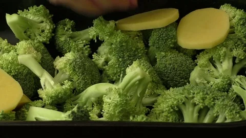 Broccoli and slices potato inside a casserole Stock Footage 75475756
