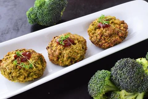 Broccoli balls deep fried on a white plate with tomato sauce, fresh broccoli Stock Photos