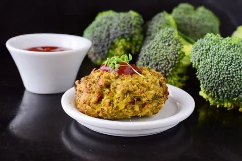Broccoli balls deep fried on a white plate with tomato sauce, fresh broccoli Stock Photos