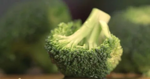 Broccoli being sliced up to cook. Macro slow motion Stock Footage 69265064