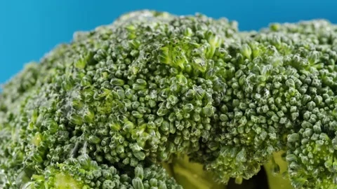 Broccoli on blue background, fresh green broccoli close-up, vitamins, raw food Stock Footage 170141877