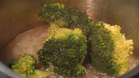 Broccoli is boiling in milk in a saucepan Stock Footage 158021933