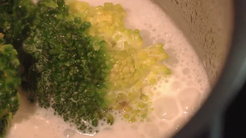 Broccoli is boiling in milk in a saucepan Stock Footage 158021940