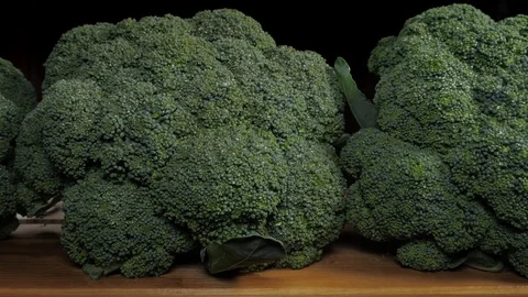 Broccoli cabbage on a wooden table. Dolly shot. Stock Footage 113572063