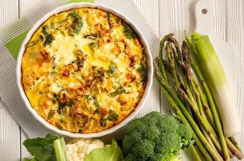 Broccoli, cauliflower and asparagus casserole with eggs and cheese. Stock Photos