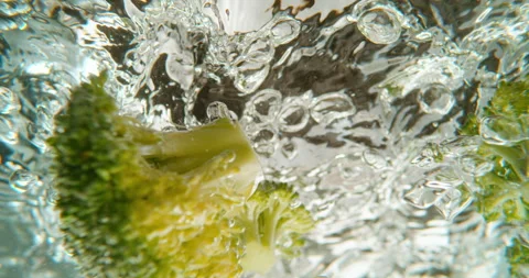 Broccoli falling into the water Stock Footage 311827359