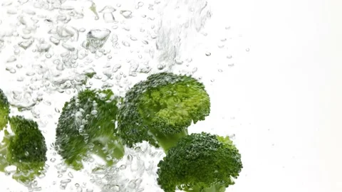 Broccoli falling in water over white Stock Footage 155139678