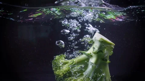 The broccoli falls into the water. Stock Footage 122982166