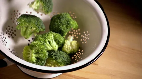 Broccoli florets falling into colander in slow motion Video stock 55453792