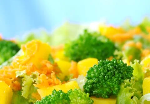 Broccoli on fresh salad Stock Photos
