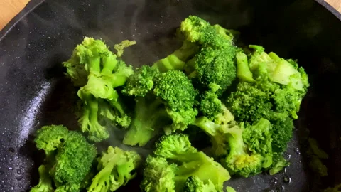 Broccoli in a frying pan while stewing. Stock Footage 265786150