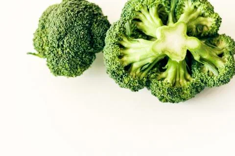 Broccoli inflorescence on white background isolated with space for text. Stock Photos