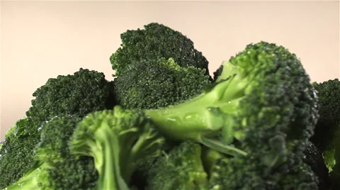 Broccoli isolated rotating on beige background Stock Footage 62378142