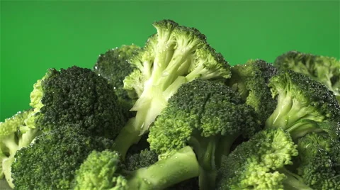 Broccoli isolated rotating on green background Stock Footage 62375324