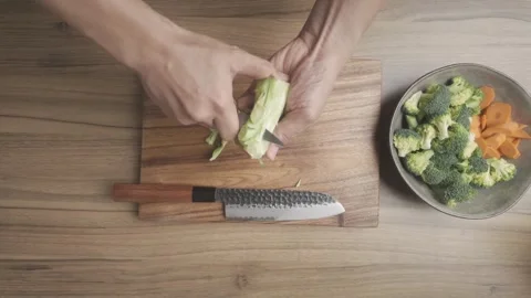 Broccoli Preparation Cutting Chopping and Slicing on Kitchen Countertop Stock Footage 329814678