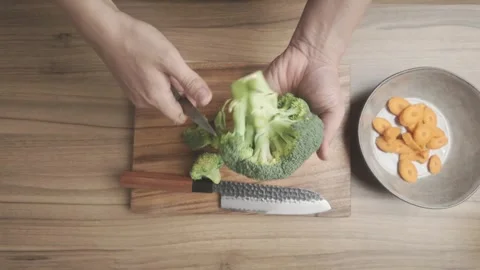 Broccoli Preparation Cutting Chopping and Slicing on Kitchen Countertop Stock Footage 329814686