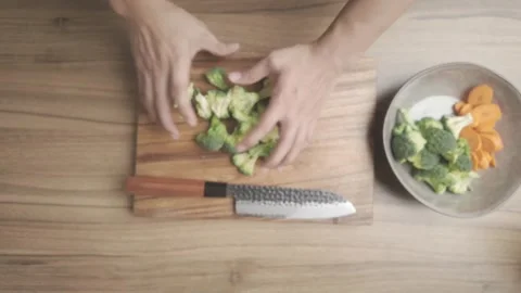 Broccoli Preparation Cutting Chopping and Slicing on Kitchen Countertop Stock Footage 329814688