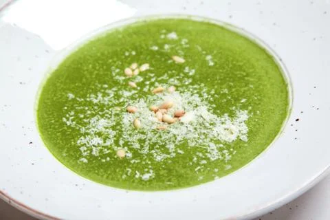 Broccoli puree soup with pine nuts and cheese. Stock Photos
