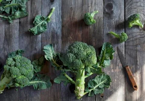 Broccoli on a rustic wooden table Stock Photos