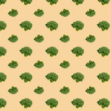 Broccoli seamless pattern on a beige background. Stock Photos