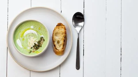 Broccoli soup in a white bowl. Healthy eating, vegetarian. Copy space. Stock Photos