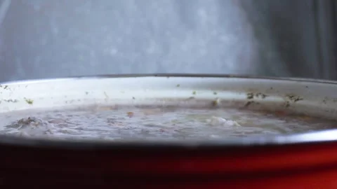 Broccoli Vegetable and Rice Soup Boiling in Red Pot on Gas Stove Stock Footage 327965970