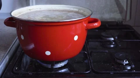 Broccoli Vegetable and Rice Soup Boiling in Red Pot on Gas Stove Stock Footage 327965973