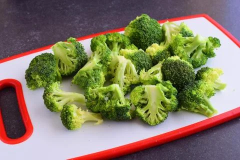 Broccoli on a white cutting board Stock Photos