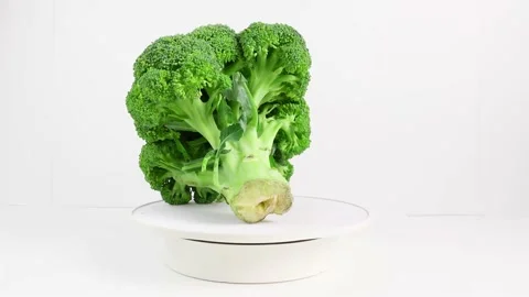 Broccoli whole cabbage rotates horizontally, fresh green vegetable isolated on Stock Footage 220885554