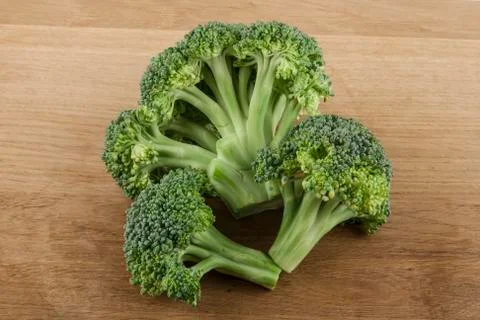 Broccoli on a wooden table Stock Photos