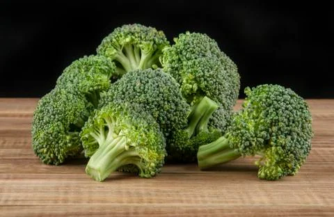 Broccoli on a wooden table Stock Photos