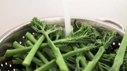 Broccolini with running water from the tap Stock Footage 140206285
