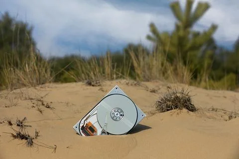 Brocken computer hard disk in sand Foto stock