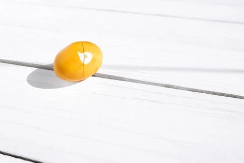Brocken yellow easter egg on white wooden background. Happy Easter. Greetin.. Stock Photos