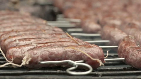 Broiling sausage on grill Video stock 64513679